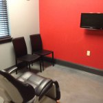 waiting room with chairs and a television