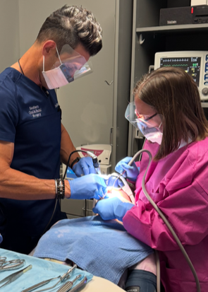 Oral surgeons preforming a procedure on a patient